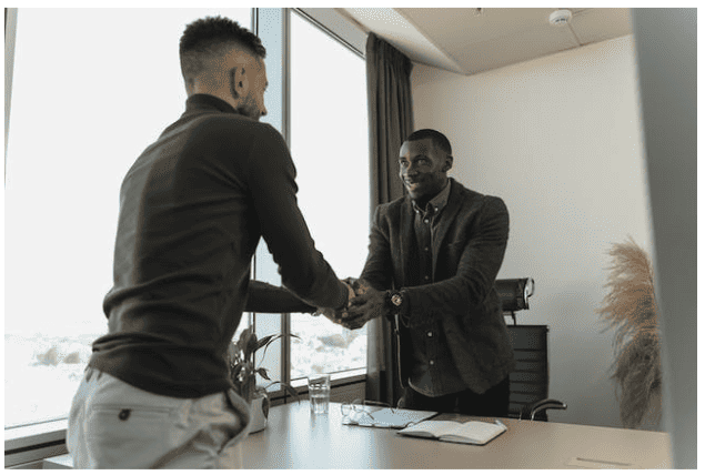 Two men shaking hands in an office